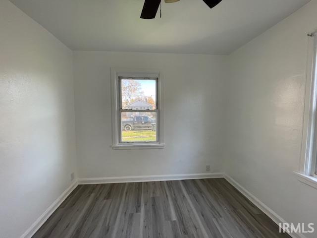 unfurnished room featuring dark hardwood / wood-style floors and ceiling fan