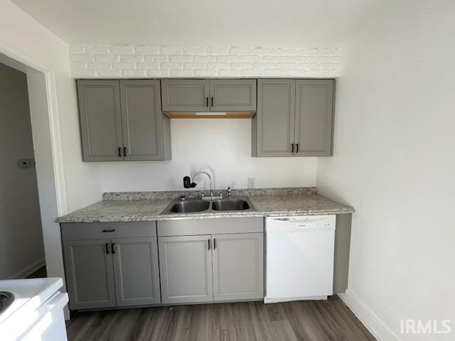 kitchen with white appliances, gray cabinets, dark wood-type flooring, and sink