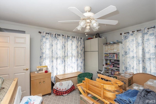 bedroom with ceiling fan and ornamental molding