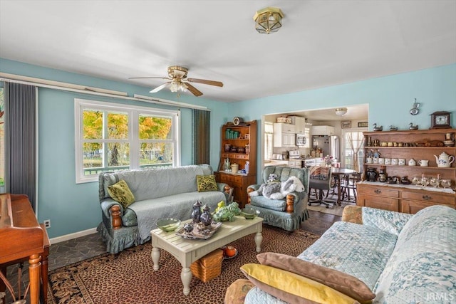 living room featuring plenty of natural light and ceiling fan