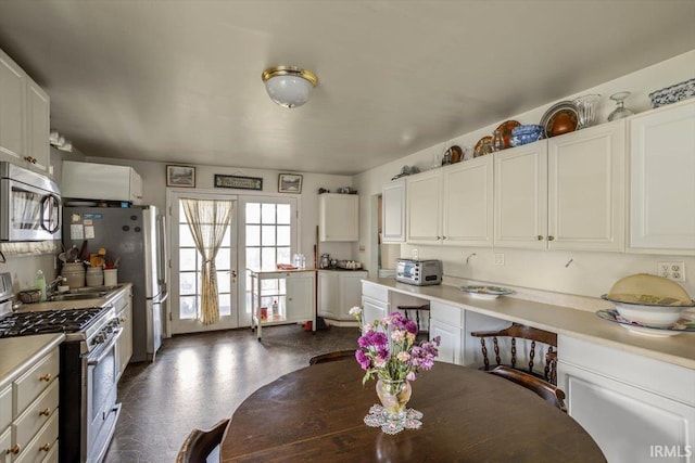 kitchen with white cabinets, appliances with stainless steel finishes, and french doors