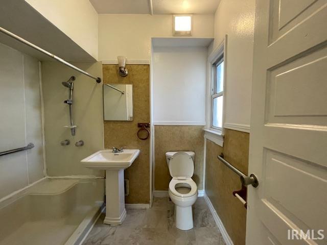 bathroom featuring toilet and walk in shower