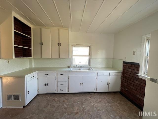 kitchen featuring white cabinets and sink