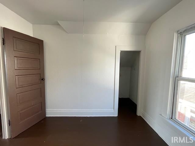 spare room with lofted ceiling