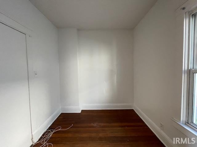 spare room with dark hardwood / wood-style flooring