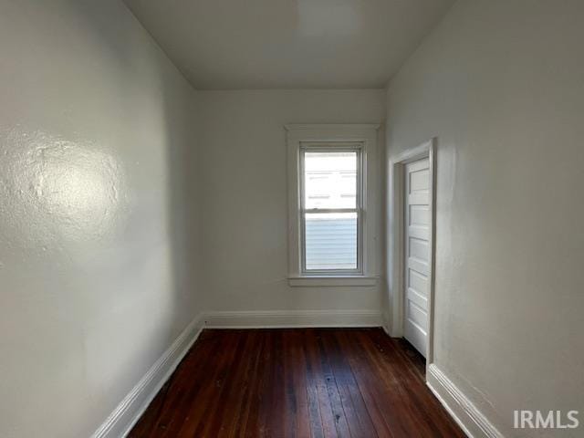 empty room with dark wood-type flooring