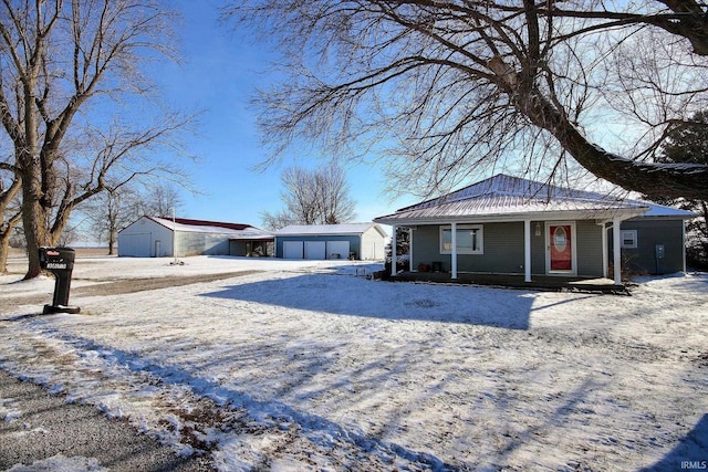 view of front facade with a porch, an outdoor structure, and a garage