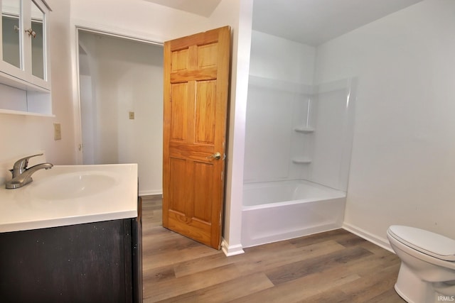 full bathroom featuring vanity, wood-type flooring, bathtub / shower combination, and toilet