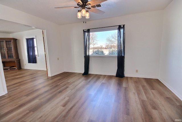 empty room featuring ceiling fan and light hardwood / wood-style flooring