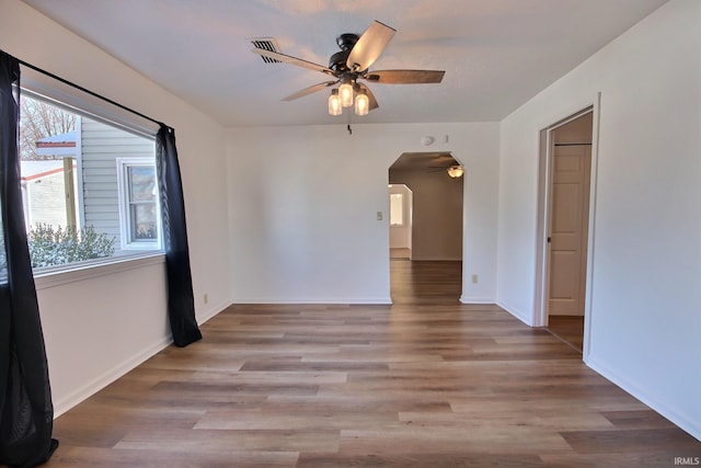 unfurnished room with ceiling fan, light hardwood / wood-style flooring, and a healthy amount of sunlight