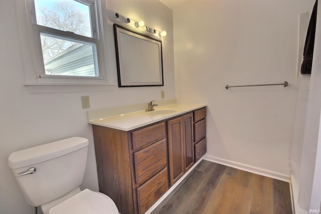 bathroom with vanity, wood-type flooring, and toilet