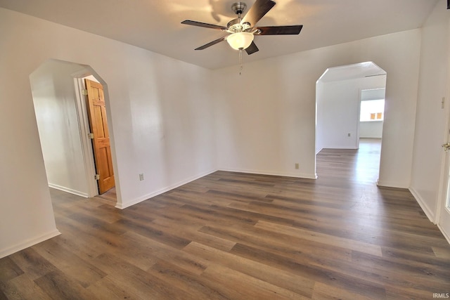 unfurnished room featuring ceiling fan and dark wood-type flooring