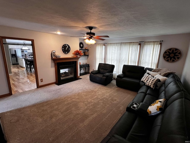 living room with carpet, a textured ceiling, ceiling fan, and a multi sided fireplace