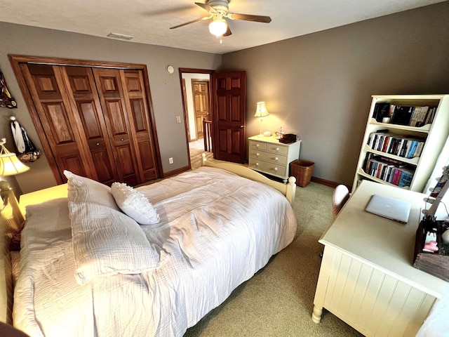 bedroom featuring ceiling fan, a closet, and light carpet