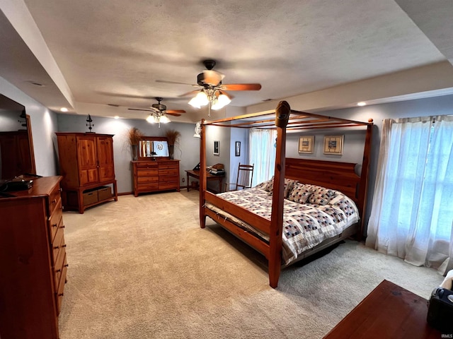 bedroom with light carpet, a textured ceiling, and ceiling fan