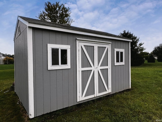 view of outbuilding with a yard