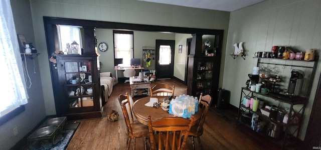 dining space with a wealth of natural light and hardwood / wood-style flooring