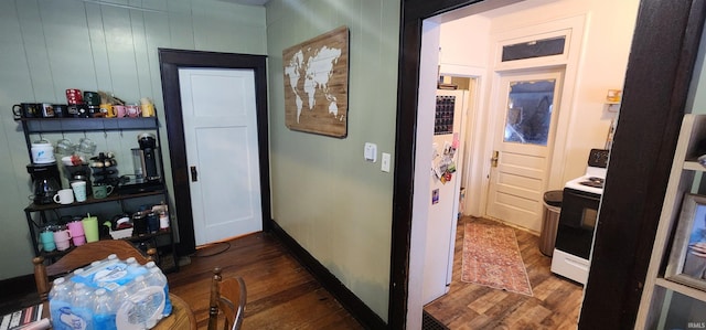 corridor with dark hardwood / wood-style flooring