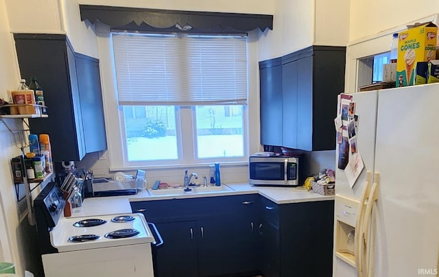 kitchen with white appliances, a wealth of natural light, and sink