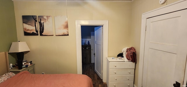 bedroom with dark hardwood / wood-style flooring