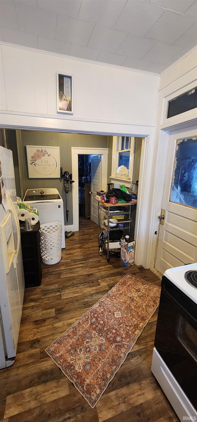 interior space with dark hardwood / wood-style flooring and washer / dryer