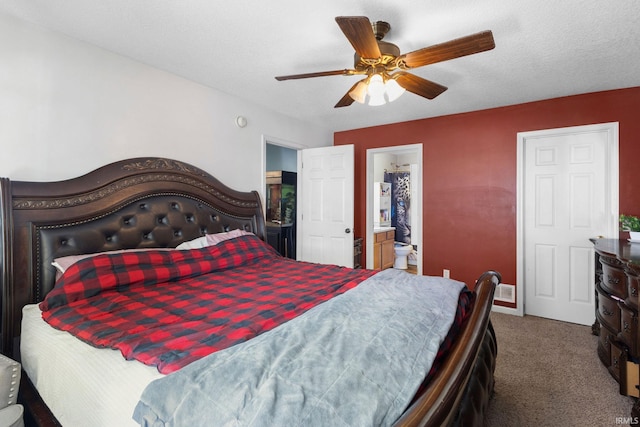 bedroom with carpet, ensuite bathroom, ceiling fan, and a textured ceiling