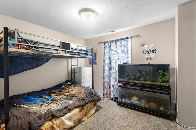 bedroom with carpet flooring and a textured ceiling