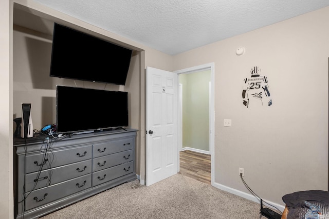 carpeted bedroom with a textured ceiling