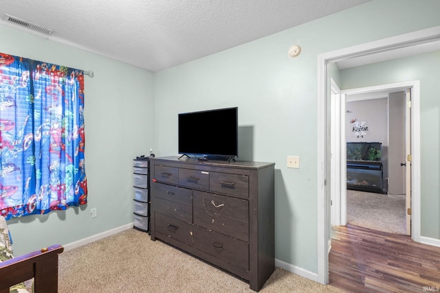 carpeted bedroom featuring a textured ceiling