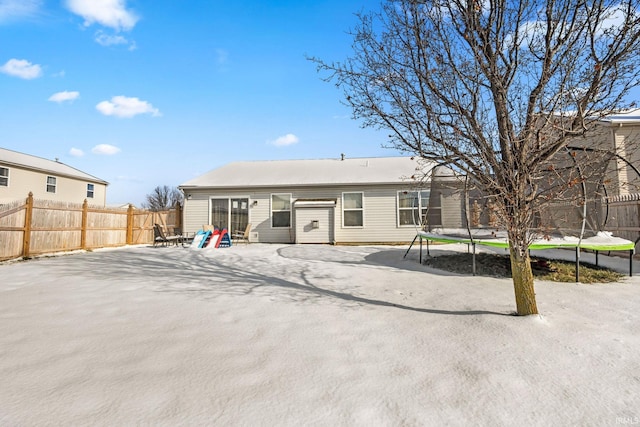 back of house featuring a patio area and a trampoline