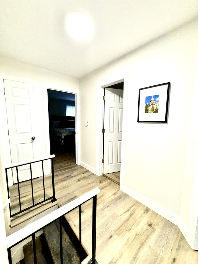 hall with light hardwood / wood-style flooring