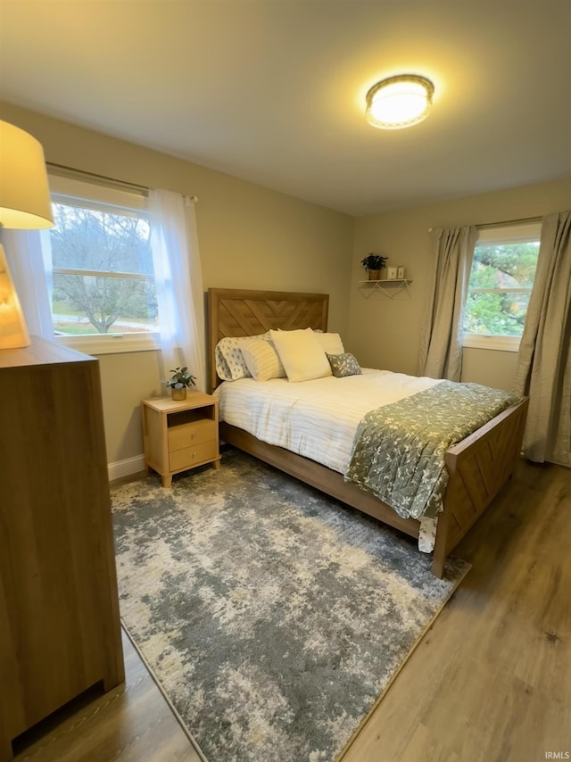 bedroom with dark wood-type flooring