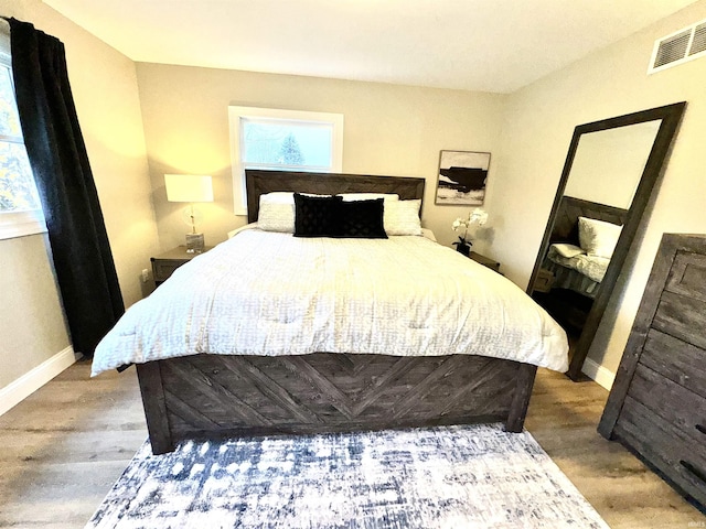 bedroom with wood-type flooring