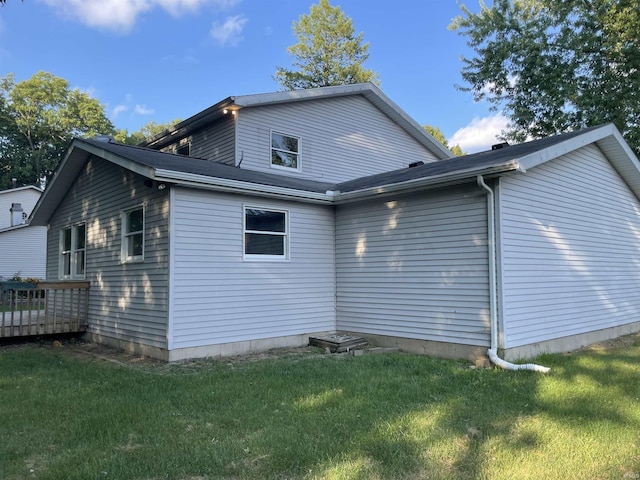 back of house with a lawn