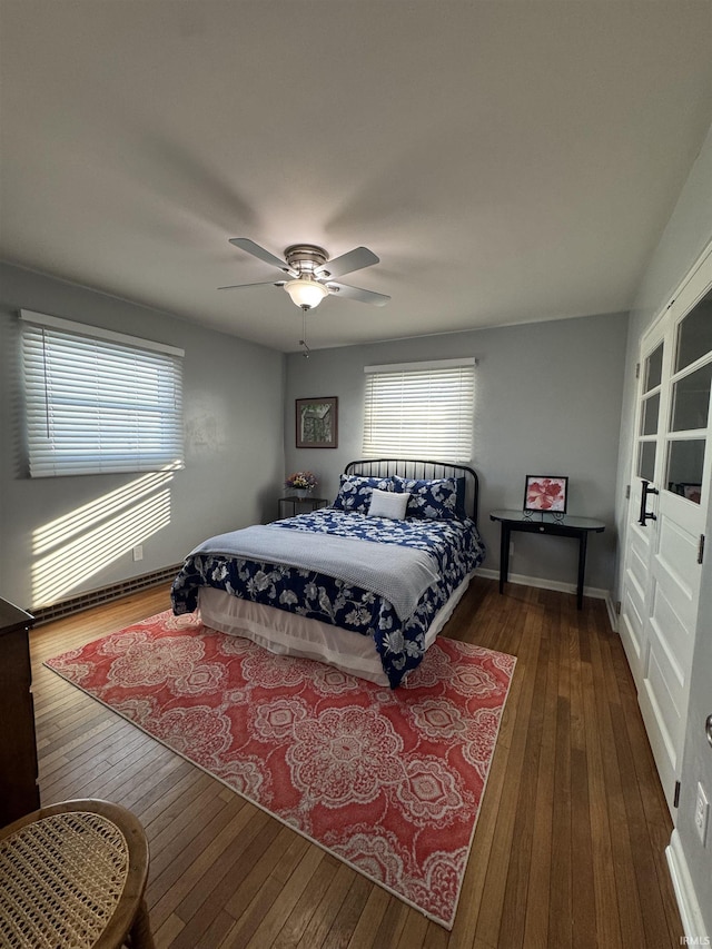 bedroom with dark hardwood / wood-style floors and ceiling fan