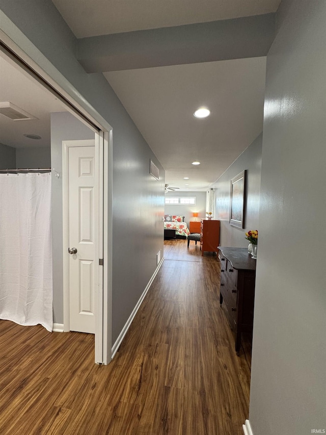 hallway with dark hardwood / wood-style flooring