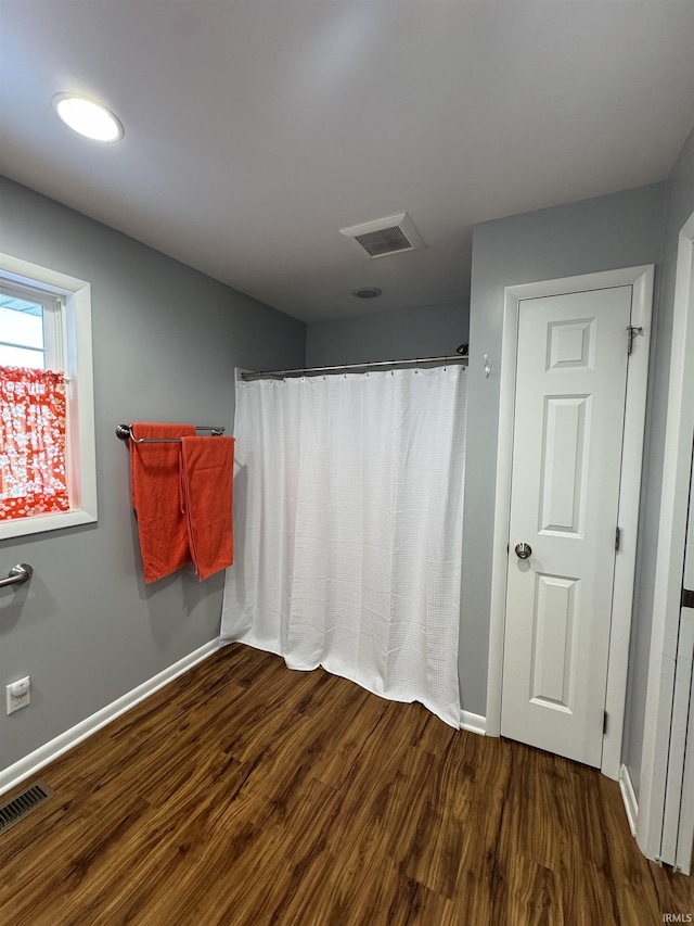 bathroom with hardwood / wood-style flooring