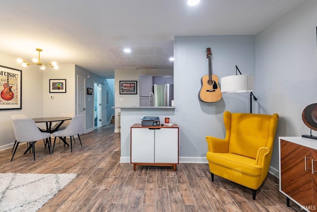 interior space with stainless steel fridge and an inviting chandelier