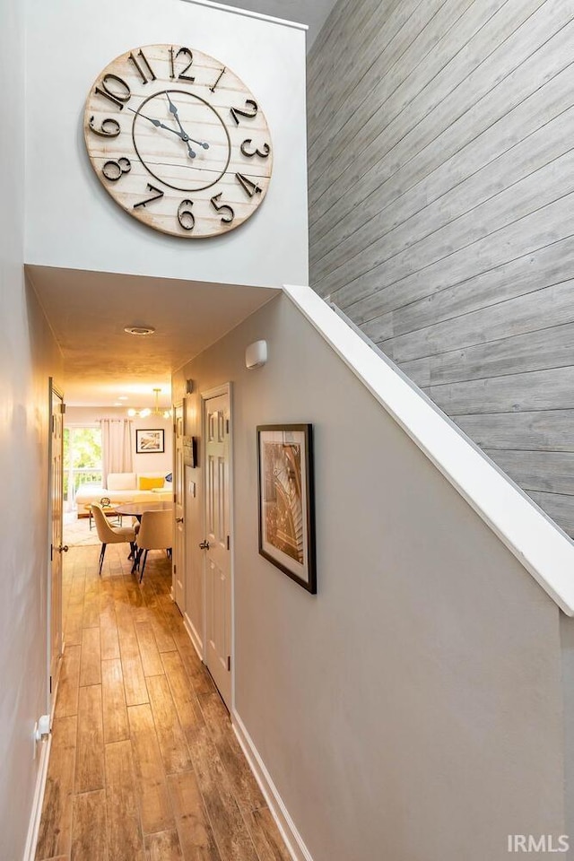 corridor with hardwood / wood-style flooring