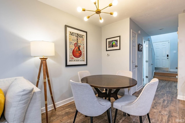 dining space with a chandelier and dark hardwood / wood-style flooring