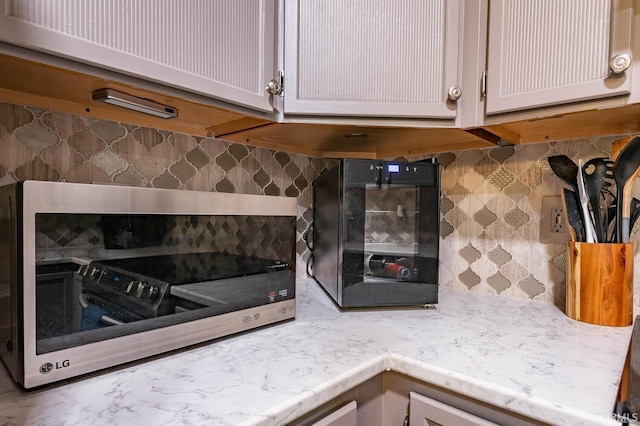 kitchen featuring backsplash and white cabinetry