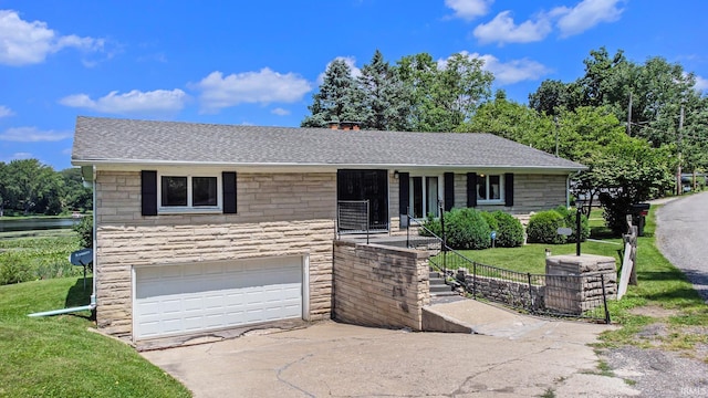 view of front of home with a front yard and a garage