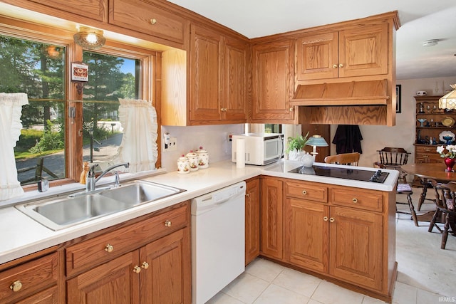 kitchen with kitchen peninsula, custom exhaust hood, white appliances, sink, and light tile patterned floors