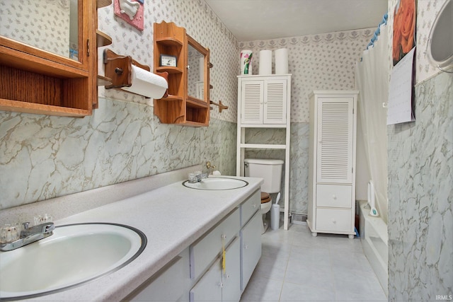 bathroom with tile patterned floors, vanity, and toilet