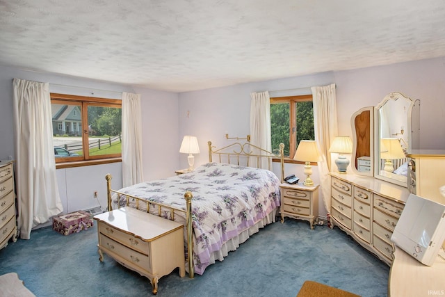 carpeted bedroom featuring a textured ceiling