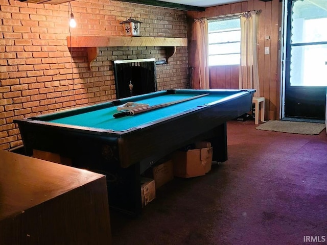 recreation room with a brick fireplace, pool table, and brick wall