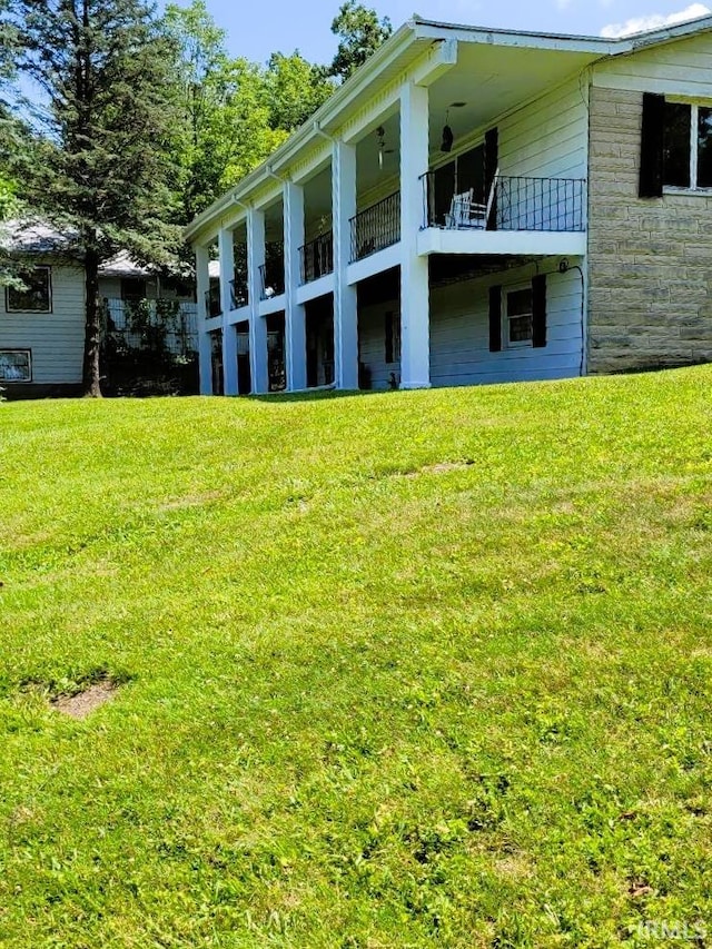 rear view of property featuring a yard