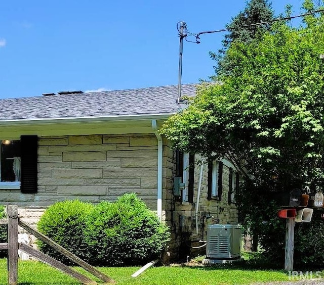 view of side of property with central air condition unit