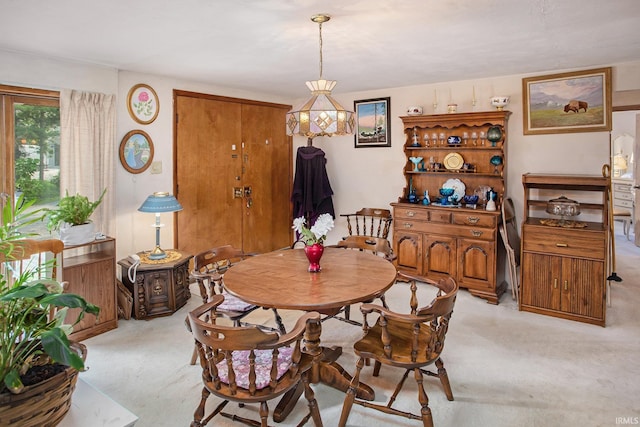 dining space with light carpet