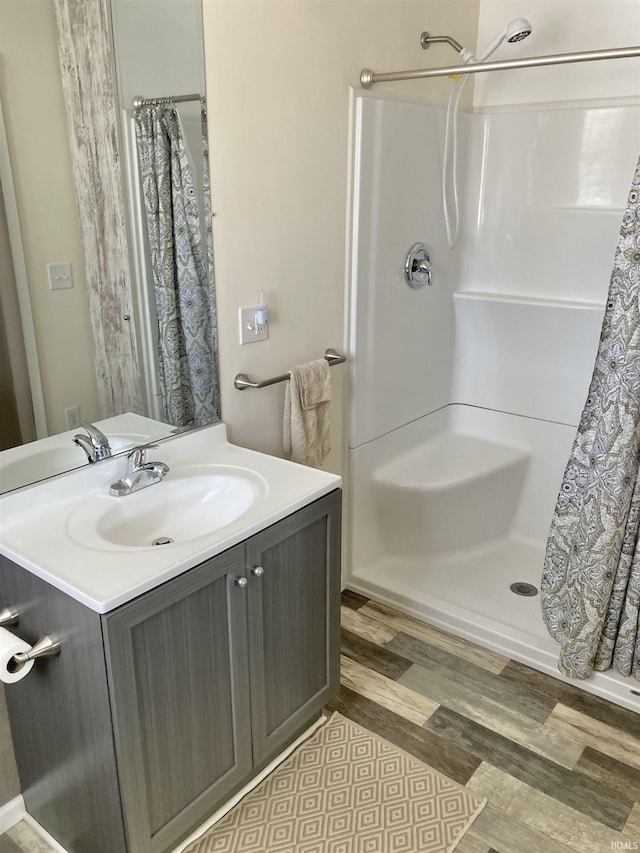 bathroom with hardwood / wood-style floors, vanity, and a shower with shower curtain